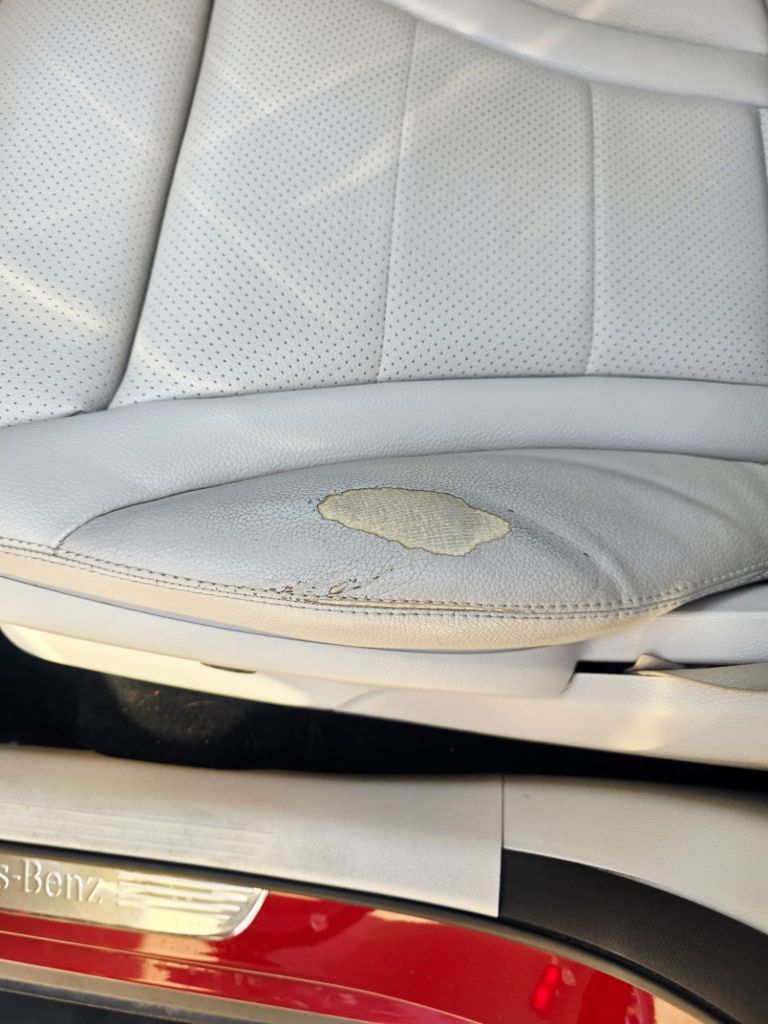 Damaged automotive leather seat before AutoPro repair